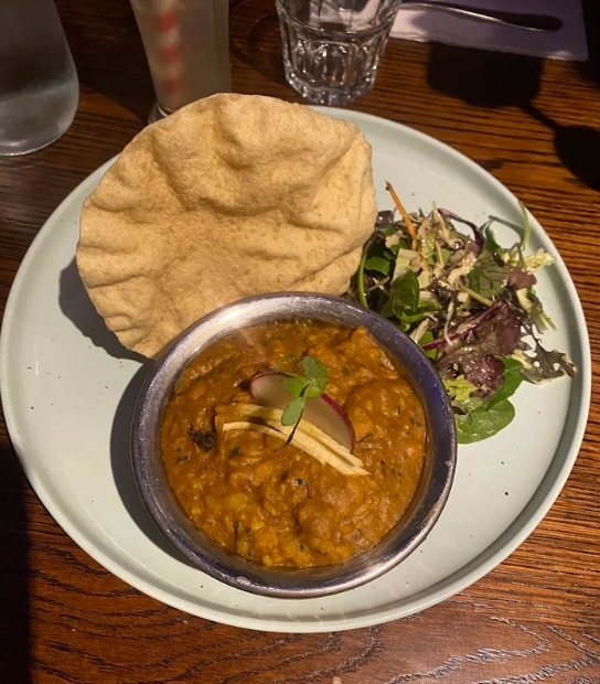 Aromatic Indian biryani served with curry and raita